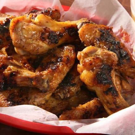 A basket of sauced and grilled chicken wings
